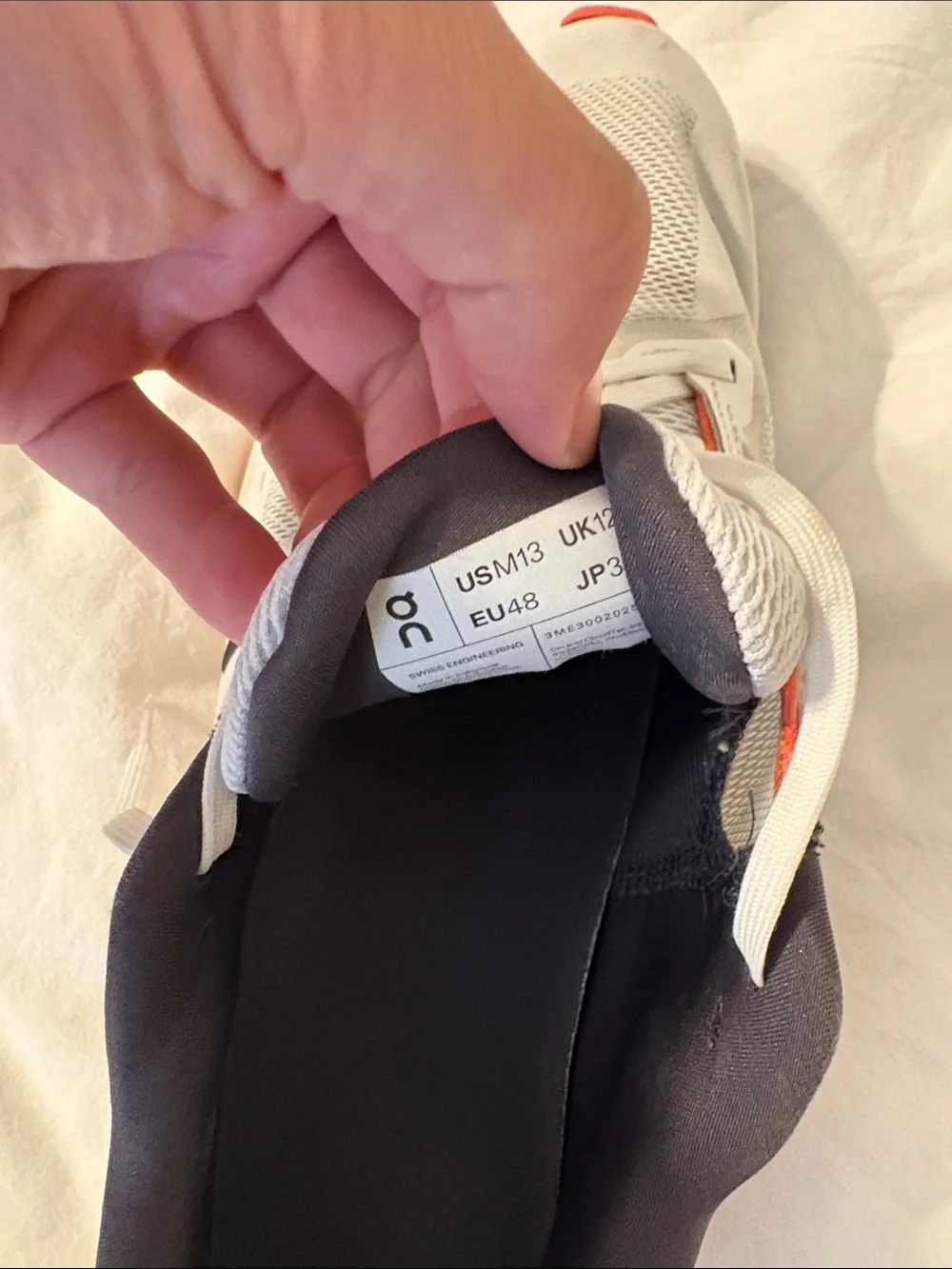 On Running Mens White Sneakers with Orange Accents